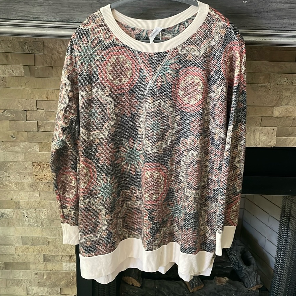 Very lightweight thermal knit top. Pairs perfectly under a cardigan.